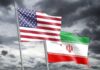 Competing Claims Follow American’s Release Flags of the United States and Iran waving against a cloudy sky