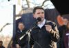 Why Critics Are Targeting Talarico Individual speaking into a microphone at an outdoor event