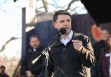 Individual speaking into a microphone at an outdoor event