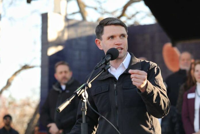 Individual speaking into a microphone at an outdoor event