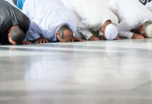 Mosque Ban Proposal Ignites Debate Group of men in traditional attire performing prayer on the floor