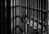 Death Penalty Case Falls Apart Close-up of prison bars casting shadows on a wall