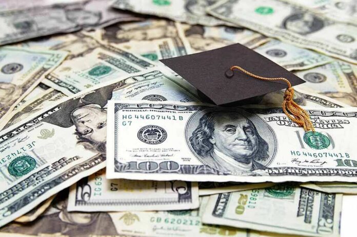 shutterstock_101980843 Graduation cap on a pile of US dollar bills