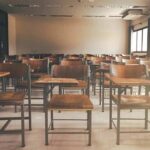 Parents Outraged: What Happened In These Classrooms? Empty classroom with rows of wooden desks and chairs