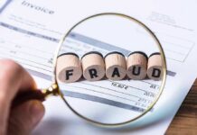 Billions In Alleged Fraud Haunt Minnesota Democrats Magnifying glass highlighting wooden blocks spelling fraud on an invoice
