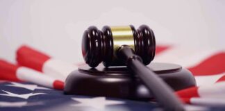 Judge’s gavel on a base over an American flag