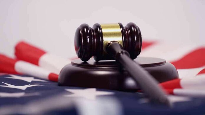 Judge’s gavel on a base over an American flag