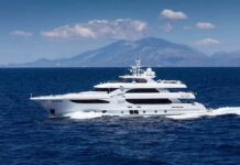 Alaska Rescue Story Puts Billionaire Under Fire Luxury motor yacht cruising on blue sea with mountains in background