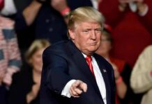 Trump Gives Iran Final Warning man in suit pointing toward the camera at an event