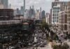 NYC Toll Sparks Debate Over Air Quality City street with heavy traffic and elevated subway tracks