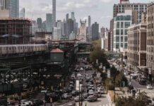 City street with heavy traffic and elevated subway tracks