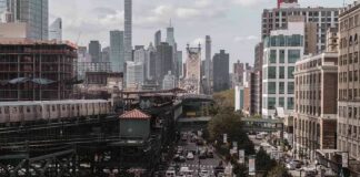 City street with heavy traffic and elevated subway tracks