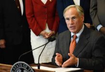 Governor Slams Brakes On Data Giants man in suit speaking at a podium with a microphone
