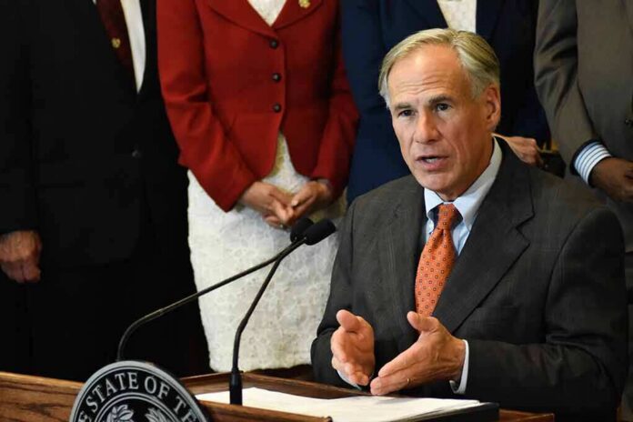 man in suit speaking at a podium with a microphone