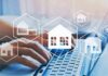 Hands typing on laptop with real estate house icons overlay