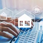 Rent Freeze, Rents Soar — What Broke? Hands typing on laptop with real estate house icons overlay