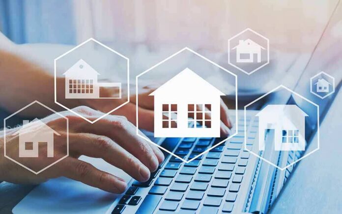 Hands typing on laptop with real estate house icons overlay