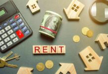 Rent payment concept with calculator, cash roll, coins, keys, and wooden house icons