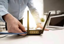 Invisible Tracking Baked Into Wi‑Fi Person plugging ethernet cable into Wi‑Fi router