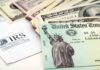 Overseas Trip Puts NYC Spending Spotlight A tax refund check from the IRS alongside various denominations of cash