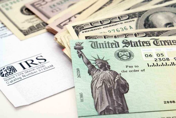 shutterstock_13772947 A tax refund check from the IRS alongside various denominations of cash