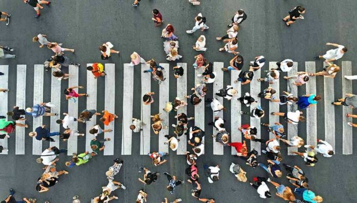 shutterstock_1486465109 Crowd of pedestrians crossing a zebra crosswalk from above