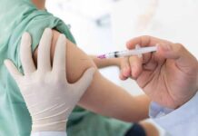 Trump Reshapes America’s Childhood Vaccine Schedule Healthcare worker giving an intramuscular injection in upper arm