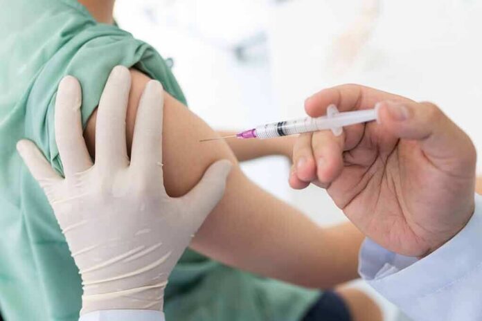 shutterstock_1740628409 Healthcare worker giving an intramuscular injection in upper arm