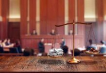 Child Support Motive in Brutal Cliff Death brass balance scale with files and gavel in a courtroom