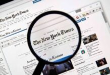 Jury Hammers NYT Over Botched Crime Story Magnifying glass over a newspaper website on a computer screen