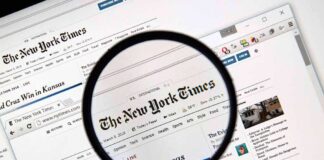 Magnifying glass over a newspaper website on a computer screen
