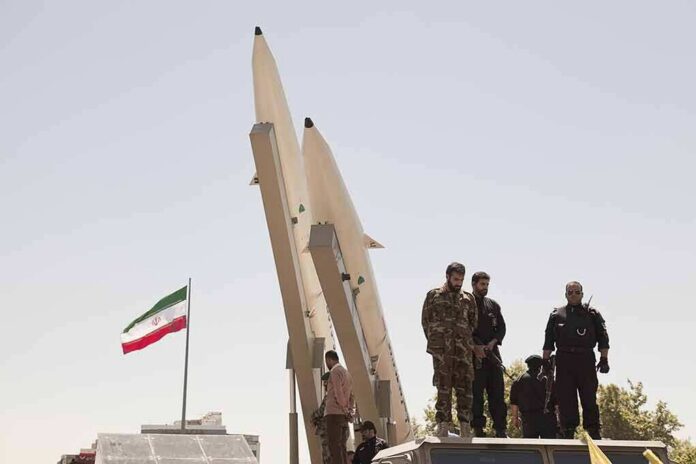 soldiers stand beside large missiles at outdoor display