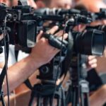 California Expands E-Bike Prosecutions television cameras on tripods at a media event