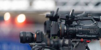 Professional video cameras on tripods