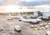 Iran Airliners Frozen Out Worldwide Airplanes at airport gates during sunset with ground vehicles and jet bridges