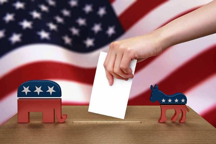 shutterstock_102884888 Hand casting ballot between Republican elephant and Democratic donkey