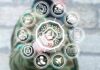 Person in camouflage touches virtual interface with cybersecurity and technology icons