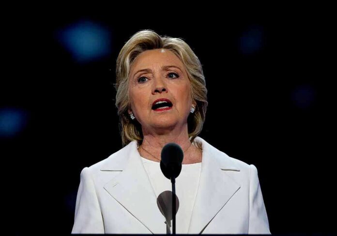 woman in white suit speaking at a microphone