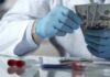 Fee-For-Service Fuels Useless Care Gloved hands in a lab coat counting US dollar bills