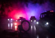 Fatal Crash Clip Rattles Chicago Handcuffs on a surface with police cars and flashing lights in the background