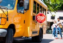 Self-Defense Claim Ignites School-Zone Fight School bus with extended stop sign near students on sidewalk