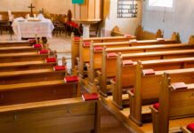 Undercover Tape Jolts Talarico’s Church Empty wooden church pews with red hymnals