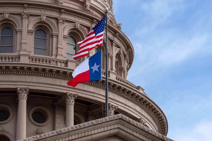 shutterstock_1216088524 Texas and U.S. flags in front of a capitol building dome