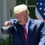 Rare Move Flips Spending Rules Donald Trump speaking at a podium and pointing during a speech