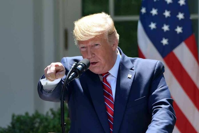 shutterstock_1424043062 Donald Trump speaking at a podium and pointing during a speech