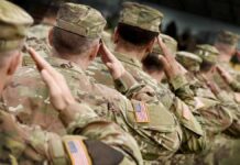 Pay Jump Triggers Army Uproar Soldiers in camouflage uniforms saluting