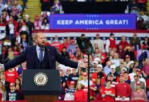 Trump Makes Final Push For GOP Candidate Crowd at a political rally with a speaker at a podium; Stephen Paea, Curtis Lofton, Walter Jones, John Sullivan, and Colin David Jones present