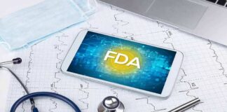 Tablet with FDA on screen amid medical tools and ECG charts