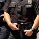 Police officers in black uniforms with duty belts