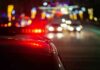 Drunk Dash Ends In Shocking Swamp Drop Police car with flashing red lights on a city street at night